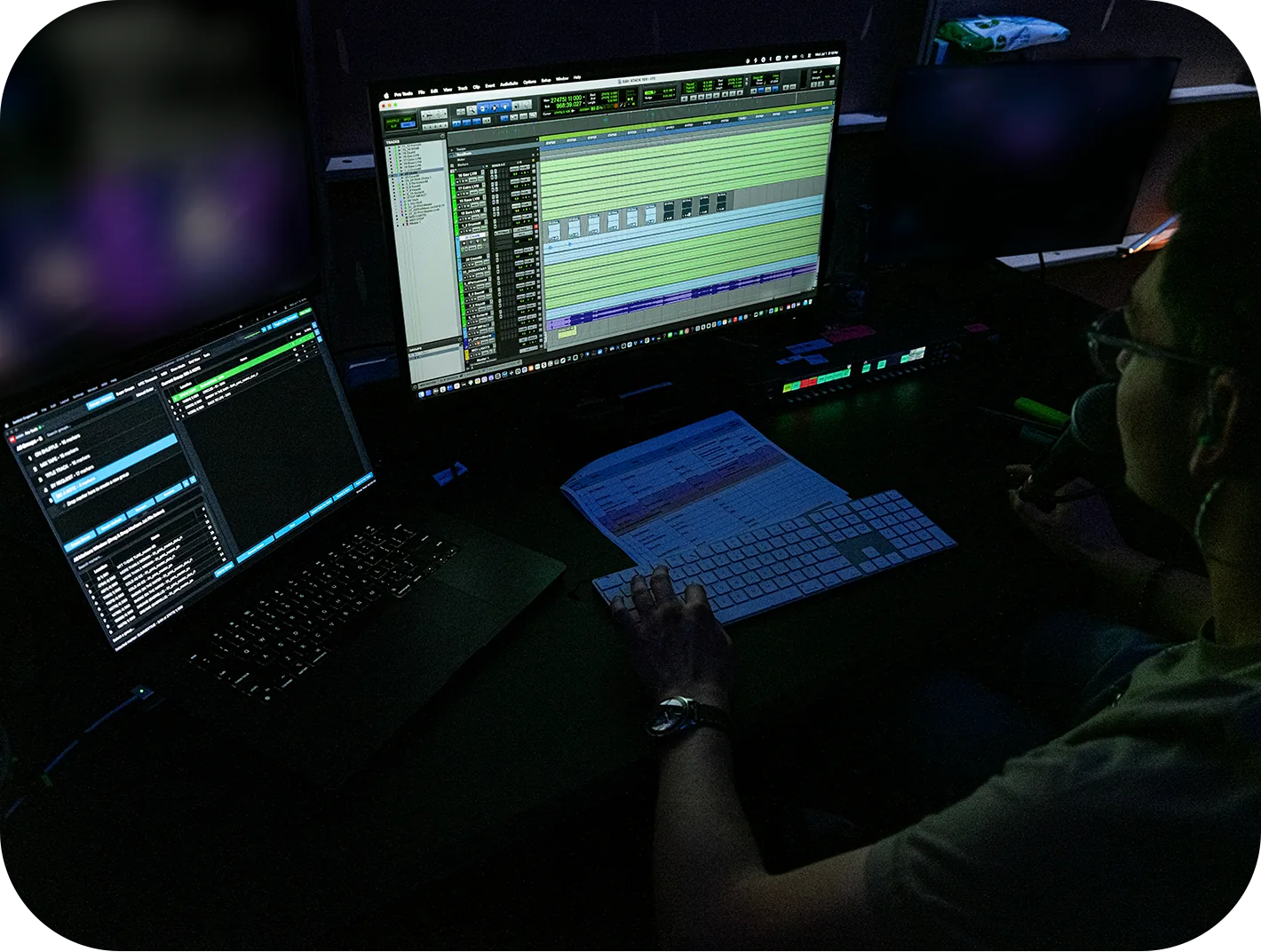 Setlist Organiser on a laptop beside a Pro Tools session on the main display, with a printed running order and a controller on the desk